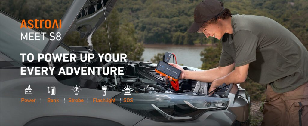 Photo of a user jump-starting a car outdoors using the AstroAI S8, with the slogan "To power up your every adventure
